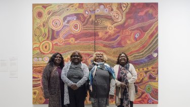Wynne Prize winners The Ken family's <i>Seven Sisters</i> in front of their work at the Art Gallery of NSW. 