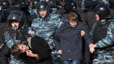 Police detain protesters during a rally in Moscow.