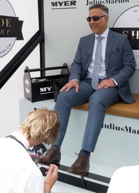 Australia Post CEO Ahmed Fahour (having his shoes shined at the Melbourne Cup) introduced two-speed mail in January.   