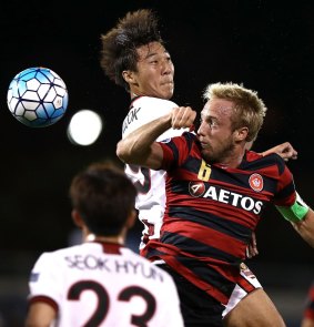 Mitch Nichols of the Wanderers competes for the ball against Hwang Ki-Wook of FC Seoul.