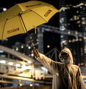 A pro-democracy activist with an umbrella, one of the symbols of the protest movement in Hong Kong, at the government complex in Admiralty on Thursday. 