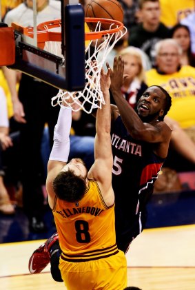 Standing his ground: Hawks forward DeMarre Carroll goes up against Cleveland guard Matthew Dellavedova.