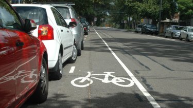 Tight squeeze: a bike lane alongside parked cars. 