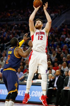 Taking aim: Pistons centre Aron Baynes shoots over Kyrie Irving.