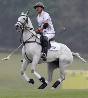 Britain's Prince Harry takes part in the annual Audi Polo Challenge at Coworth Park polo club in Ascot.