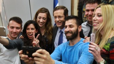 Zionist Union leader Isaac Herzog, centre, poses for a photo with voters in Tel Aviv. 