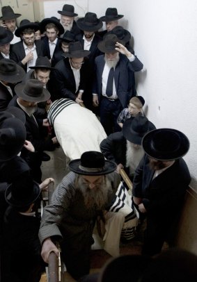 Ultra-Orthodox Jewish men carry the covered body of Rabbi Moshe Twersky during his funeral.