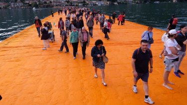People walk on 'The Floating Piers' by Christo, on Lake Iseo in northern Italy. 