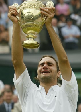 Roger Federer holds up the trophy after beating Mark Philippoussis in 2003.
