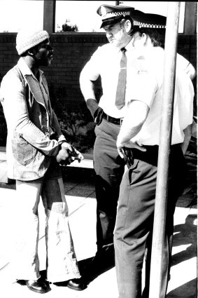 Clem Curtis (left) was taken in handcuffs from a jet on a warrant from the NSW state police on an assault charge in 1975.