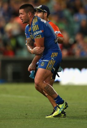 Painful: Nathan Peats heads for the sideline.