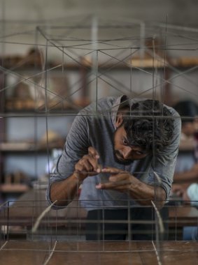 A worker in Bijoy Jain's Mumbai studio with a  prototype of the MPavilion design.
Photo: Nicholas Watt