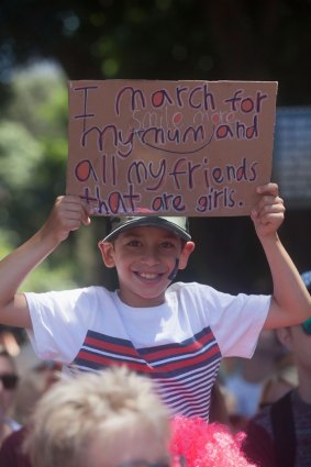 A young boy holds a sign at the Sydney march.