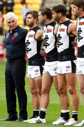 Mick Malthouse and Marc Murphy line up during the pre-match ceremony.