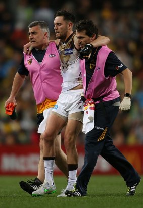 Jack Gunston leaves the field with a knee injury.