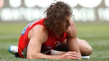 Down for the count: Kurt Tippett on the turf against GWS.