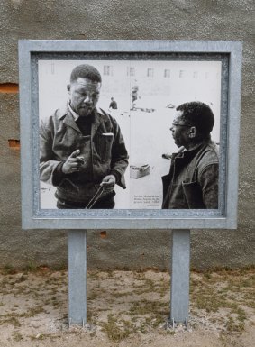 A photo of Nelson Mandela and Walter Sisulu when they were prisoners at Robben Island under apartheid regime stands at the UNESCO World Heritage Site.