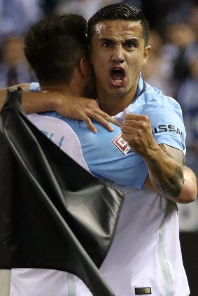Tim City: Cahill celebrates after scoring the opening goal.