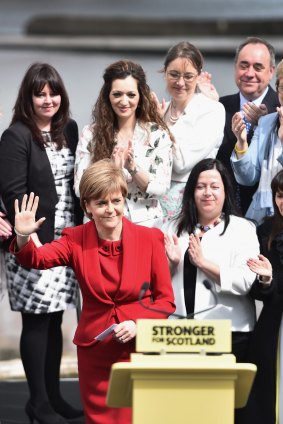 Nicola Sturgeon greets supporters on the morning after the general election. In the background on the right is her predecessor Alex Salmond, who led the party's bid for independence from the UK and is now a Westminster MP.