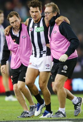 Lame Pie: Levi Greenwood is helped off after hurting a knee. 