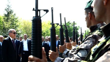 Erdogan, left, reviews police special forces at their HQ in Ankara after the July coup attempt.