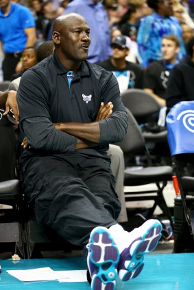 Legend: Owner Michael Jordan watches his team from his courtside seat.