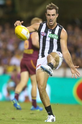 Steele Sidebottom of the Magpies kicks during the early part of Saturday's game against Brisbane.