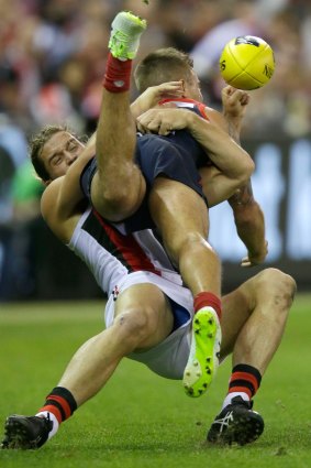 All wrapped up: Saint Josh Bruce tackles the Demons' Ben Kennedy.