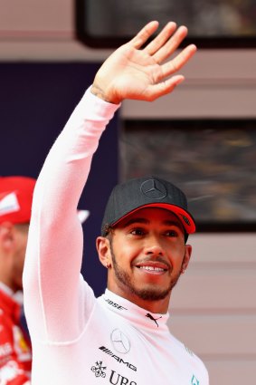 Polesitter Lewis Hamilton waves to the crowd after qualifying in Shanghai. 