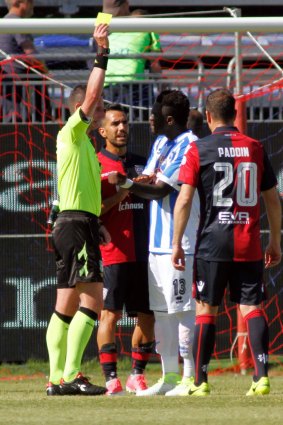 Referee Daniele Minelli shows a yellow card to Muntari at the weekend.