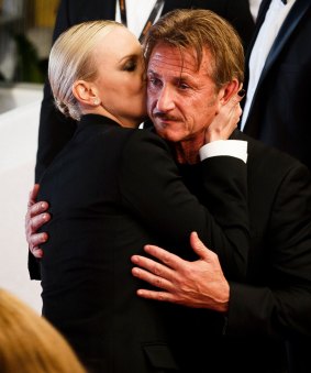 Sean Penn and Charlize Theron embrace each other as they leave the screening of "The Last Face" in Cannes.