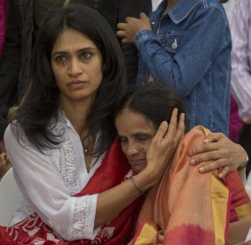 Prabha Kumar's mother is comforted.