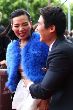 Dami Im and her husband Noah Kim arrive at the 2014 ARIA Awards red carpet. 