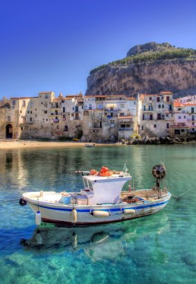A boat moored in the port of Cefalu, Sicily. 
