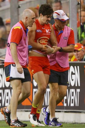 Alex Sexton of the Suns leaves the field injured.