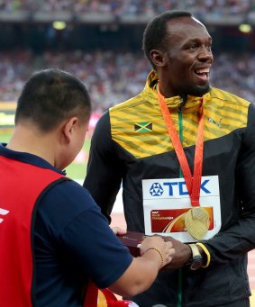 Conciliatory gesture: Usain Bolt is presented with a gift by the segway driver.