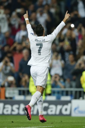 Real Madrid's Cristiano Ronaldo celebrates after scoring during a Group A Champions League soccer match between Real Madrid and Shakhtar Donetsk at the Santiago Bernabeu stadium in Madrid, Spain, Tuesday, Sept. 15, 2015. (AP Photo/Paul White)