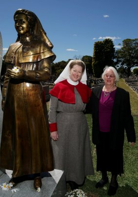Coral Levett and Jennifer Furness pose with the statue of Alice Cashin.