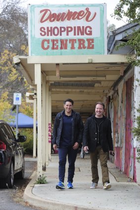 Developers of the Downer shops, Njegosh Popovich and Theo Poulos under the original shopping centre sign.