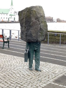 Reykjavik's 'Unknown Public Servant' sculpture, weighed down by the 'rock' of great responsibility.