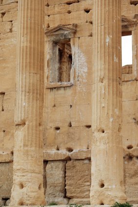 A  picture taken last year shows damage caused by shelling on a wall in Palmyra, a UNESCO World Heritage site.