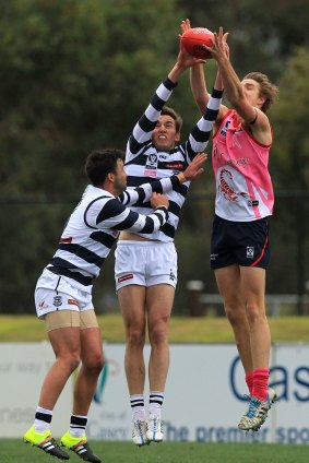 Cameron Tudor (centre) and Jimmy Bartel (left) of the Cats contest an aerial ball during the match between the Casey Scorpions and Geelong on Saturday.