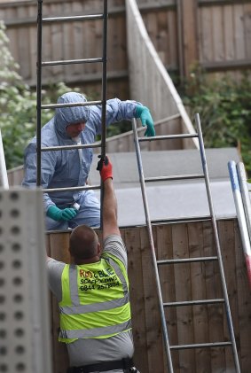 A forensic police officer works at a block of flats raided by police in connection with the London Bridge attack in Barking.