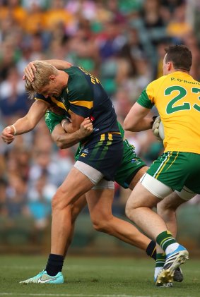 International Rules: Nick Riewoldt, of Australia, wrestles with James McCarthy, of Ireland, during the  Test at Patersons Stadium,  Perth.  