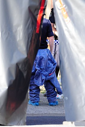 Police collect evidence from a Cairns home where eight children were killed.