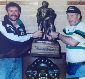 Former Raiders massage therapist Bobby Griffin, right, with the Winfield Cup.