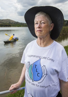 Tuggeranong Lake Carers Group members Lesley McGrane and Bill Perry remove rubbish from the lake.