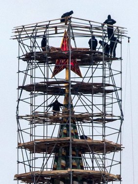 The nature of Russian news has changed. Pictured: workers stand on scaffolding erected around the top of the Spasskaya tower (Saviour Tower) of the Kremlin as it undergoes repair, in Moscow this month.