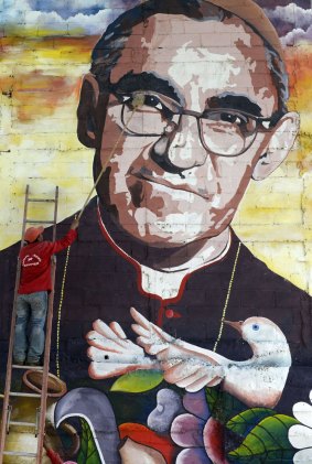 A man cleans a mural of Salvadorean Archbishop Oscar Romero in Panchimalco, 20 kilometres south of San Salvador.