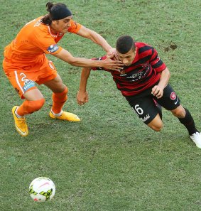 Jerome Polenz of the Roar and Jaushua Sotirio of the Wanderers compete for the ball. 